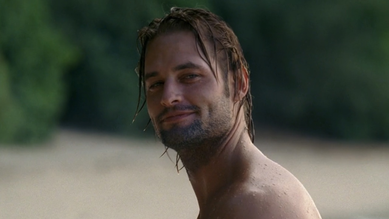 Sawyer smiling mischievously in Season 1 of Lost. 