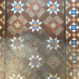 close up of victorian hallway tiles during restoration
