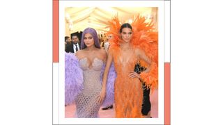 Kylie Jenner wearing a purple embellished gown, with a purple feathered shawl and Kendall Jenner wearing an orange embellished gown with orange feathered wings attend The 2019 Met Gala Celebrating Camp: Notes on Fashion at Metropolitan Museum of Art on May 06, 2019 in New York City.