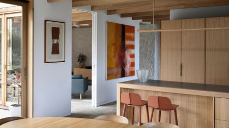 An open concept dining room and kitchen space with wood accents