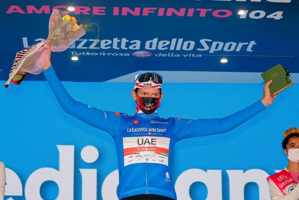 Team UAE Emirates rider US Joe Dombrowski celebrates the best climbers blue jersey on the podium after winning the fourth stage of the Giro dItalia 2021 cycling race 187 km between Piacenza and Sestola EmiliaRomagna on May 11 2021 Photo by Luca BETTINI AFP Photo by LUCA BETTINIAFP via Getty Images