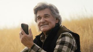 Preston smiling holding phone outside in The Madison Season 1