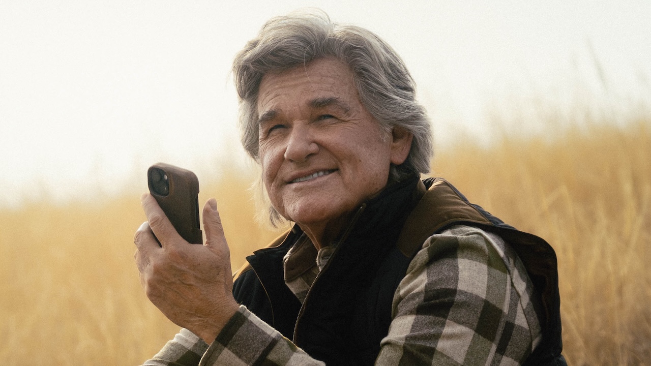 Preston smiling holding phone outside in The Madison Season 1