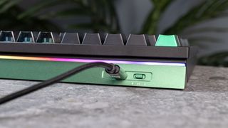 The Lemokey L5 HE keyboard on a stone surface with a gray wall in the background