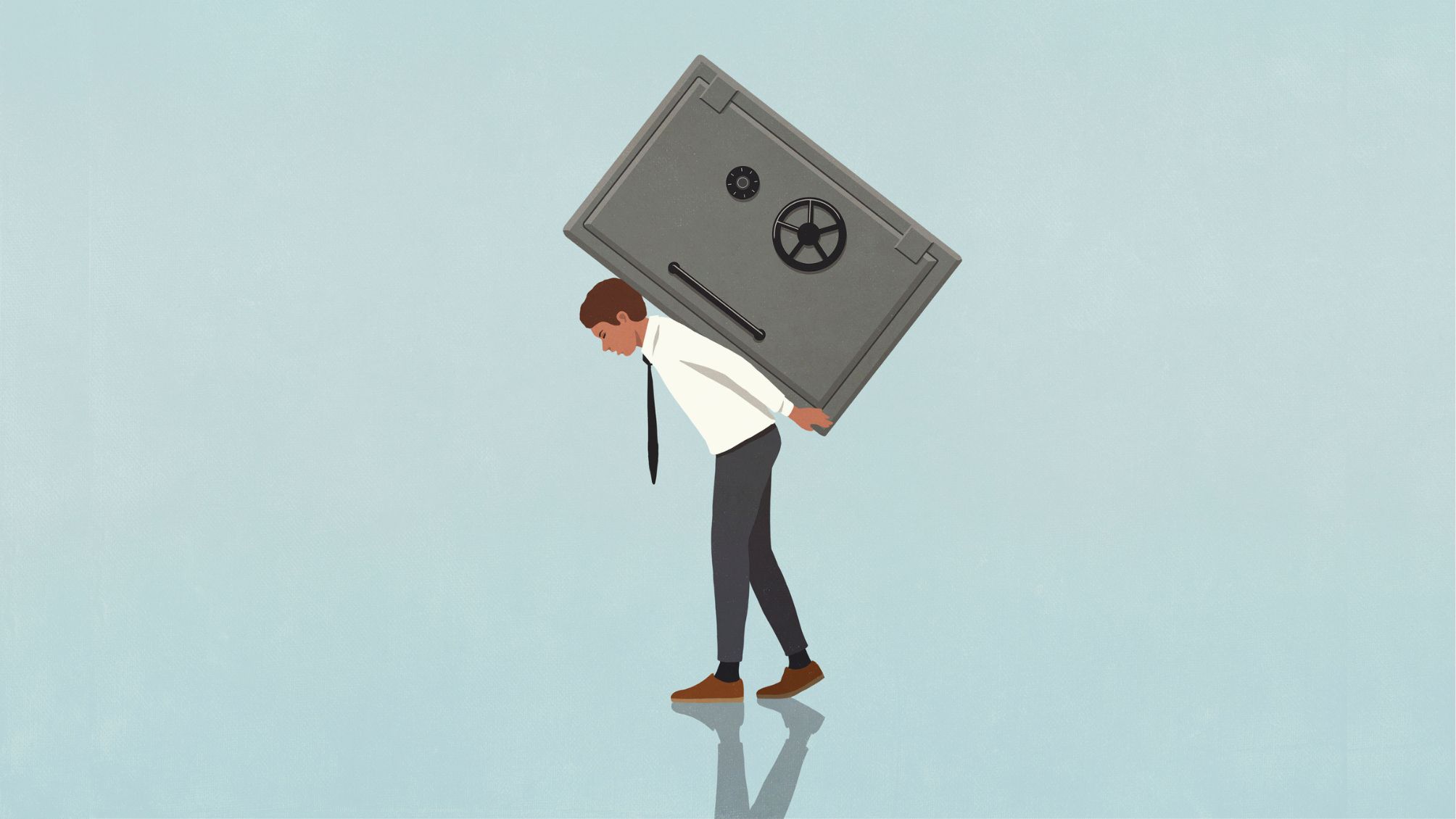 Businessman carrying heavy vault on back against blue background 