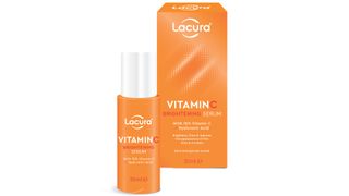 Lacura Vitamin C Brightening Serum in a bright orange bottle, with a box on the right. Picked by our beauty team as the best vitamin c serum for a budget price point