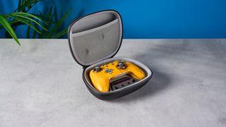 Photograph of the PB Tails Metal Crush Defender gaming controller in a metal case