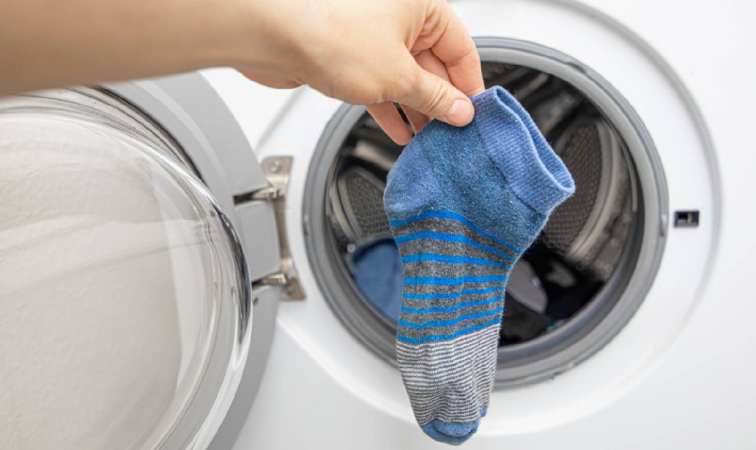Socks held up against a washing machine 
