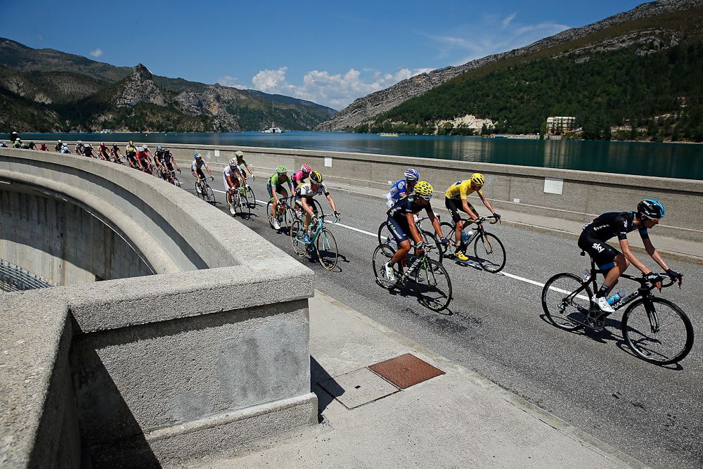 The peloton crosses a bridge during stage 17.