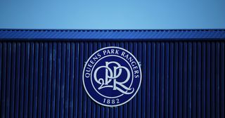 A general view of the Queens Park Rangers logo on the stand roof inside the stadium prior to the Sky Bet Championship match between Queens Park Rangers and Coventry City at The Kiyan Prince Foundation Stadium on April 02, 2021 in London, England. Sporting stadiums around the UK remain under strict restrictions due to the Coronavirus Pandemic as Government social distancing laws prohibit fans inside venues resulting in games being played behind closed doors.