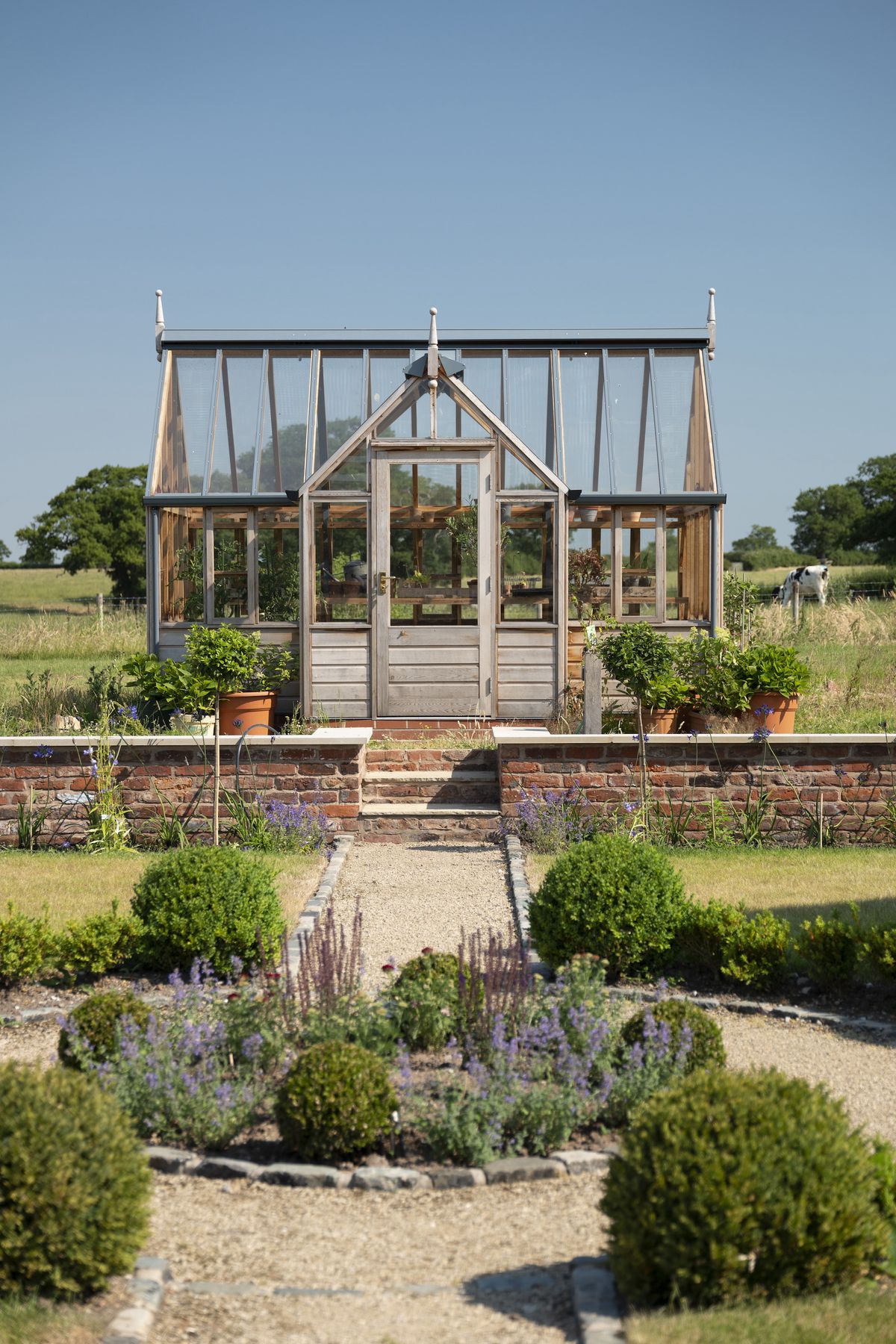 country cottage garden with greenhouse