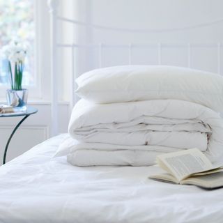 White bedding on top of mattress