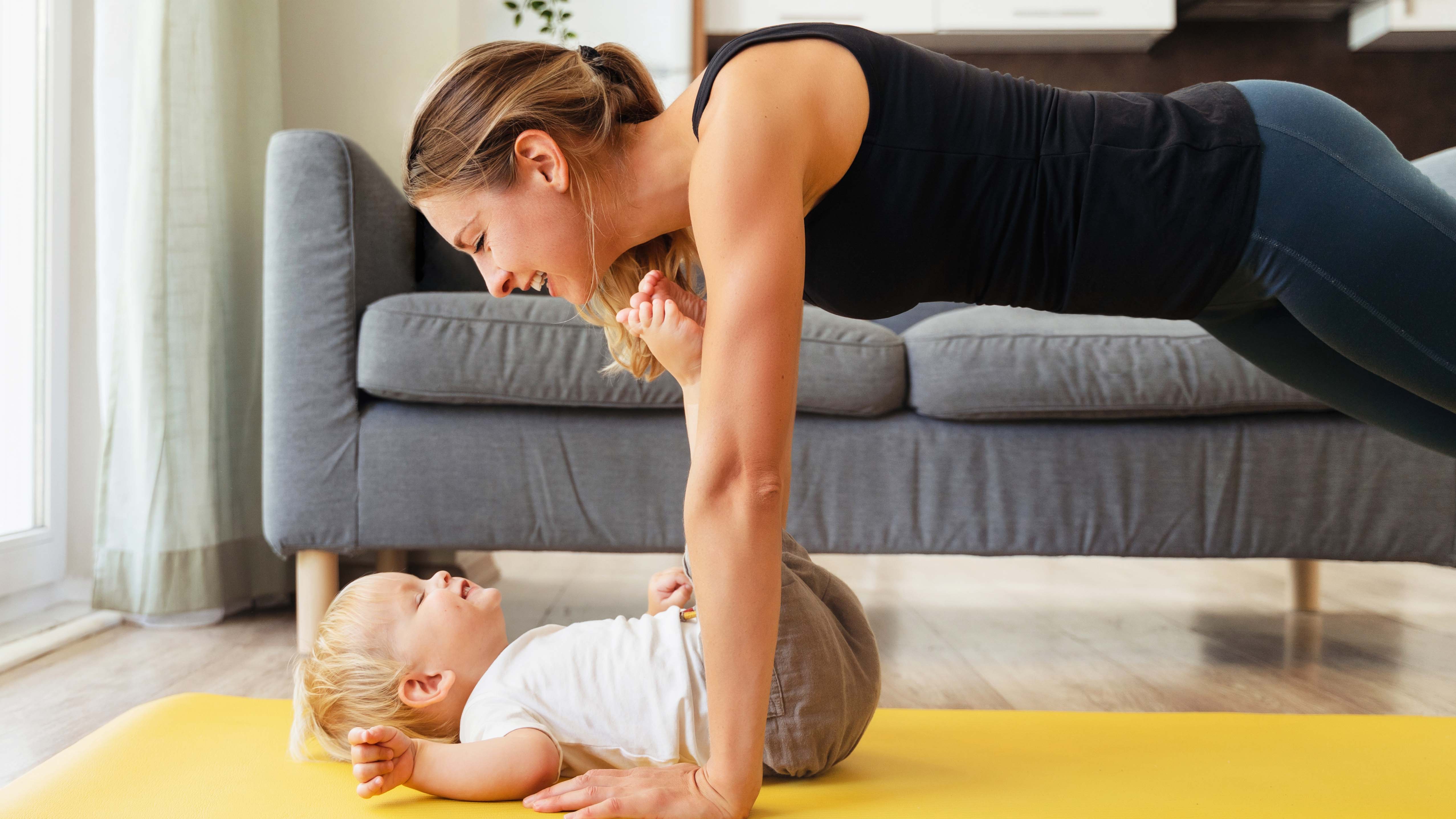 a photo of a mum doing a workout with her baby