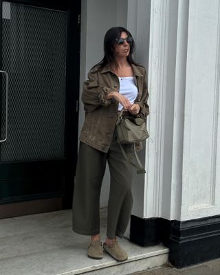 Influencer wears olive green trousers.