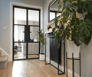 Origin 0I-30 glass doors in a hallway with black Crittall-style framework