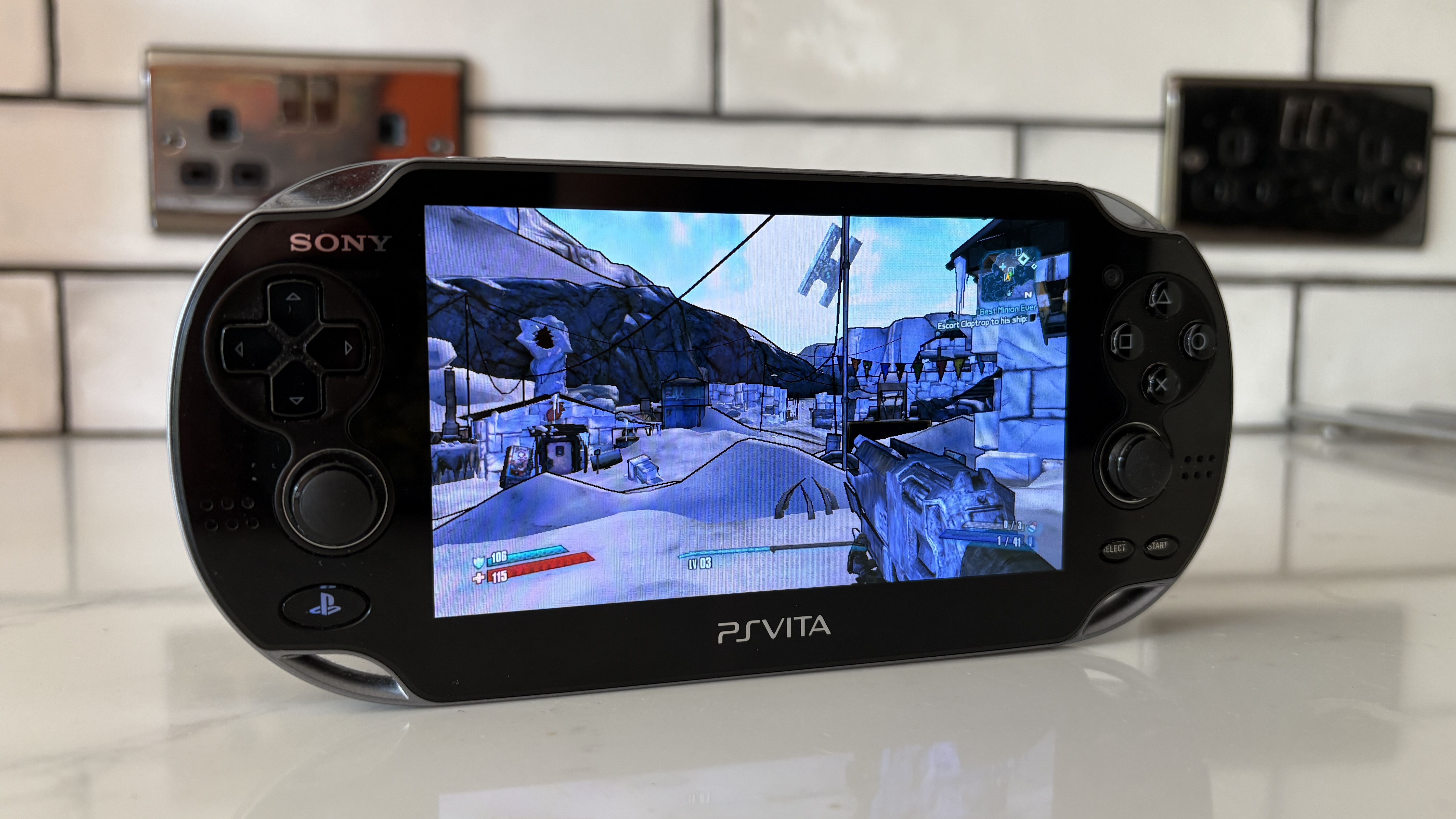PS Vita on white countertop with Borderlands 2 on display
