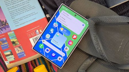 The Samsung Galaxy Z Fold 8 in a suitcase, on top of various items.