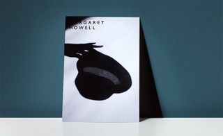 On A5 card, this invitation captures the shadow of a hand holding a hat worn by Howell's models