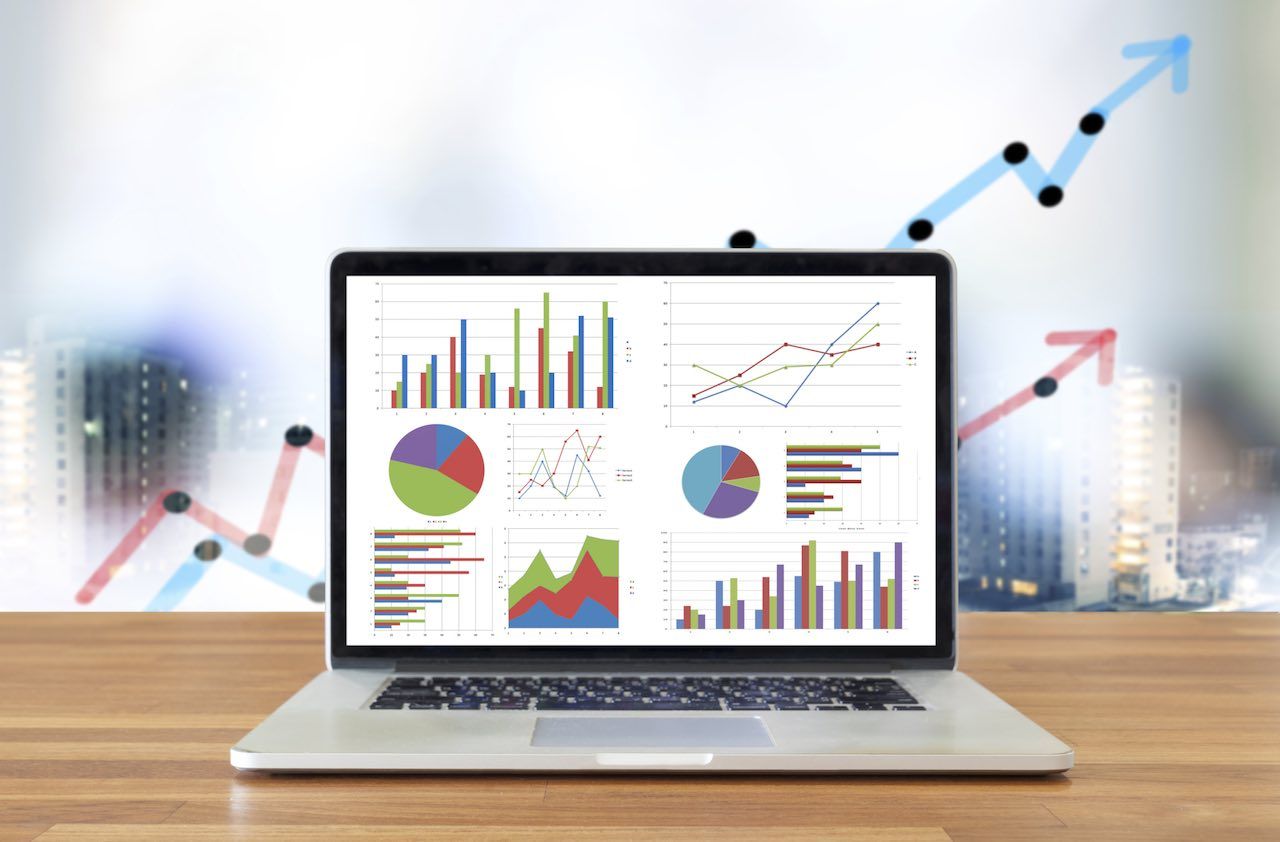 Laptop on wooden table showing charts and graph, Analysis Business Accounting,Statistics Concept.