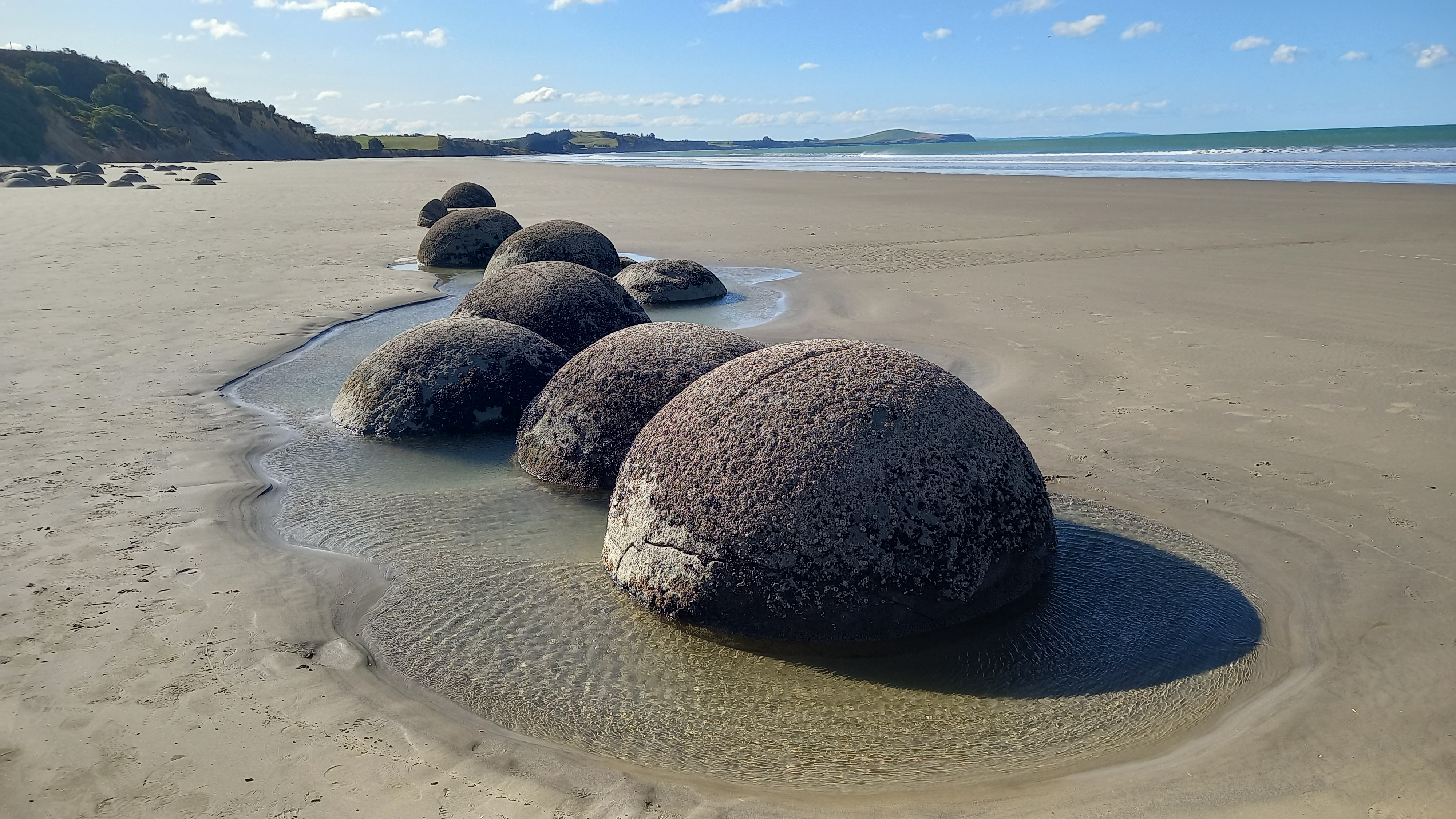 Three large round rocks on a beach