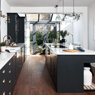 kitchen with black furniture and lantern roof with timber flooring