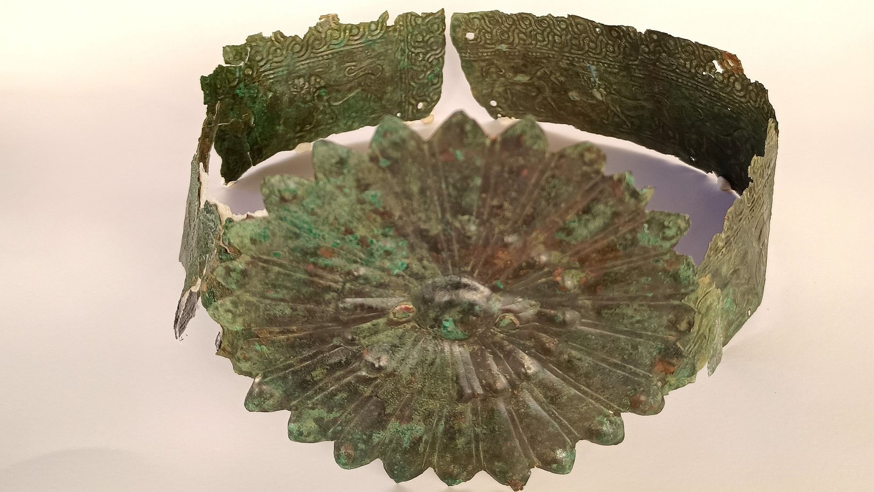 a bronze crown with a large rosette