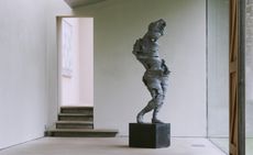 Grey man art sculpture with no arms 