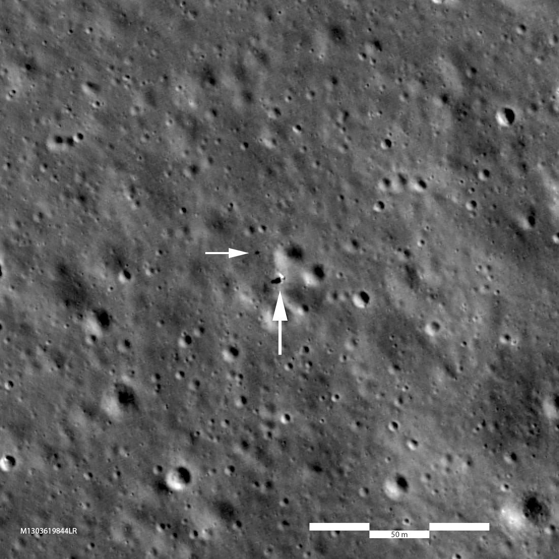 Looking down on the Chang'e 4 landing site; lander is just beyond tip of large arrow, rover at tip of small arrow. Image is 468 meters (1535 feet) across, 2x enlargement, LROC M1303619844LR.