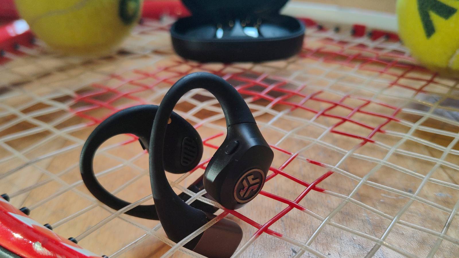 The JLab Epic Open Sport on a tennis racquet.
