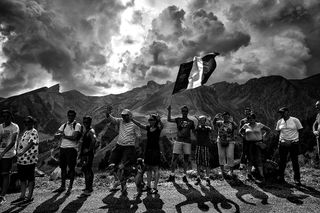 A supporter holds a French national flag at the Tour de France