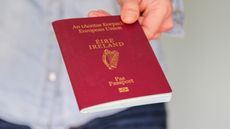 Close up of man's hand holding an Irish passport
