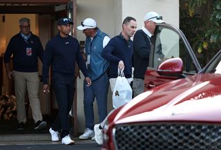 Tiger Woods walks towards a car at the 2024 Genesis Invitational