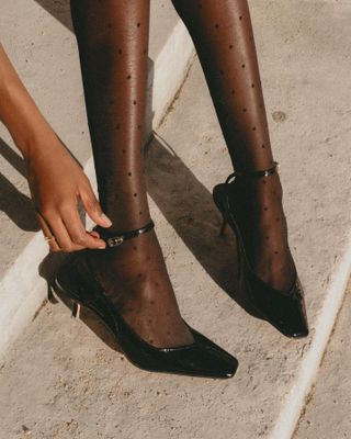 Sheer tights with black patent leather shoes.