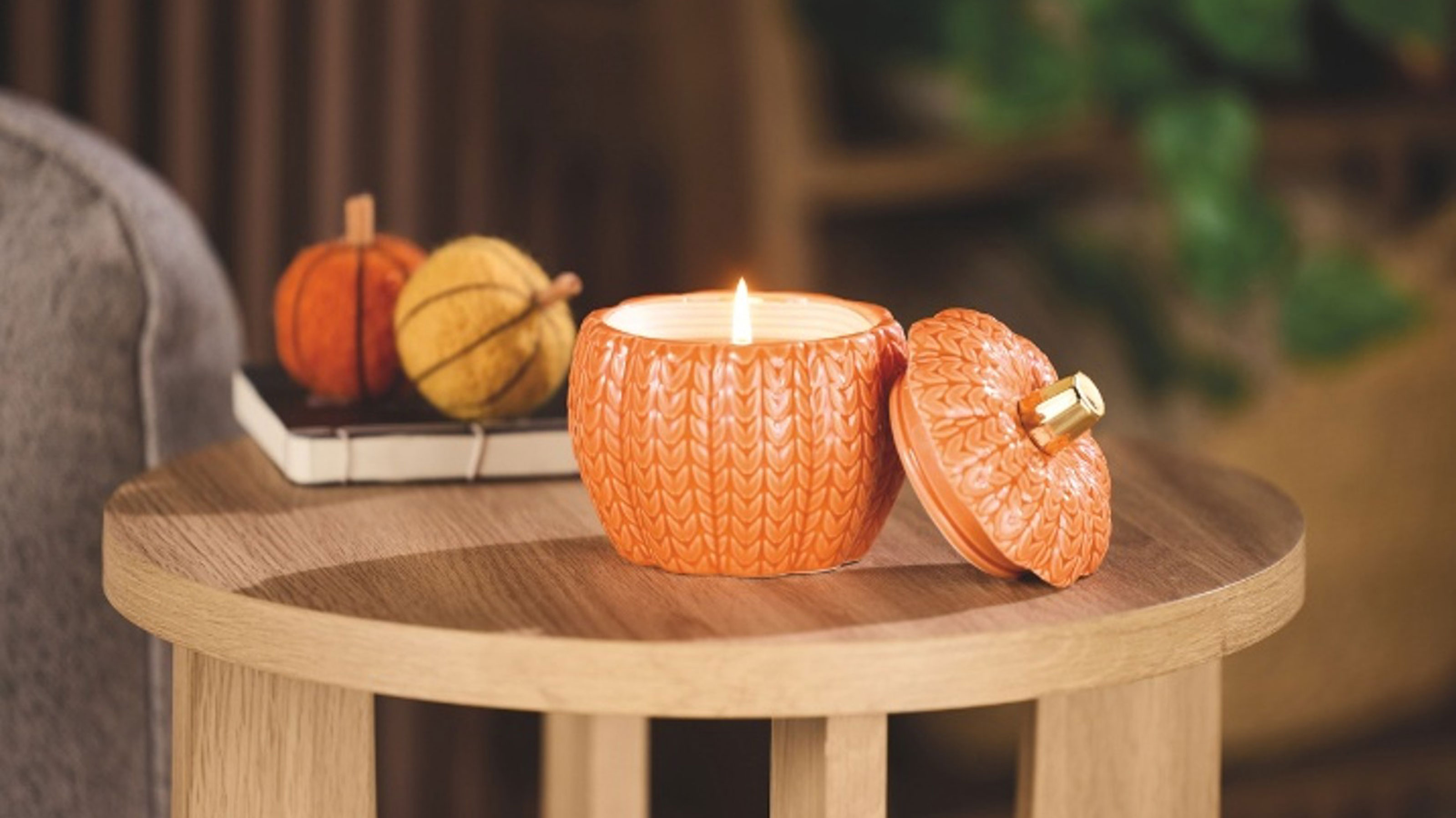 Pumpkin candle on sidetable