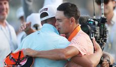 Wyndham Clark and Rickie Fowler hug on the 18th green