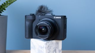 A black Canon PowerShot V1 compact vlogging camera