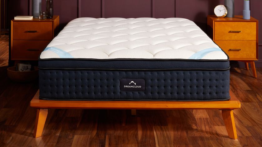 The The DreamCloud Premier Hybrid Mattress on a wooden bedframe