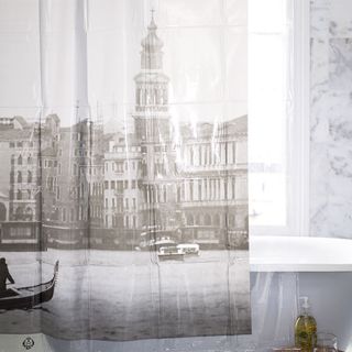 bathroom with white wall and cityscape print shower curtain