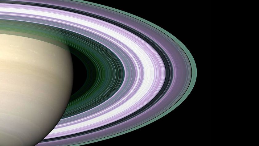 a pale yellow planet surrounded by white concentric rings