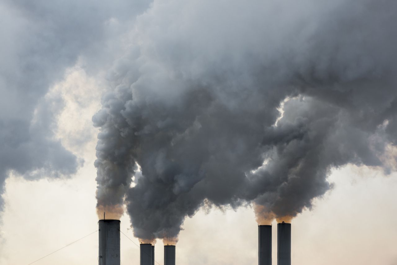 Plumes of smoke rise from chimneys at an industrial area