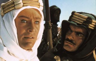 peter o'toole wearing a headwrap and staring off into the desert in lawrence of arabia