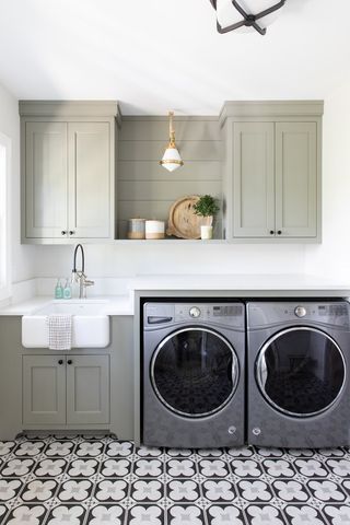 gray laundry room with sink and cabinets
