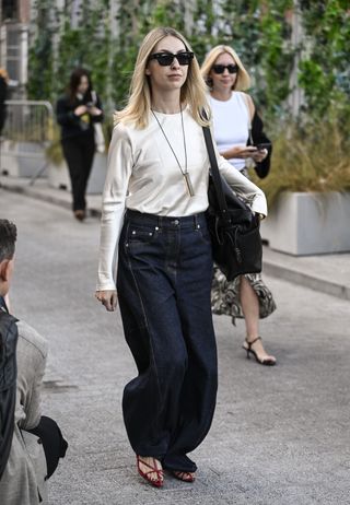 woman in satin top and jeans