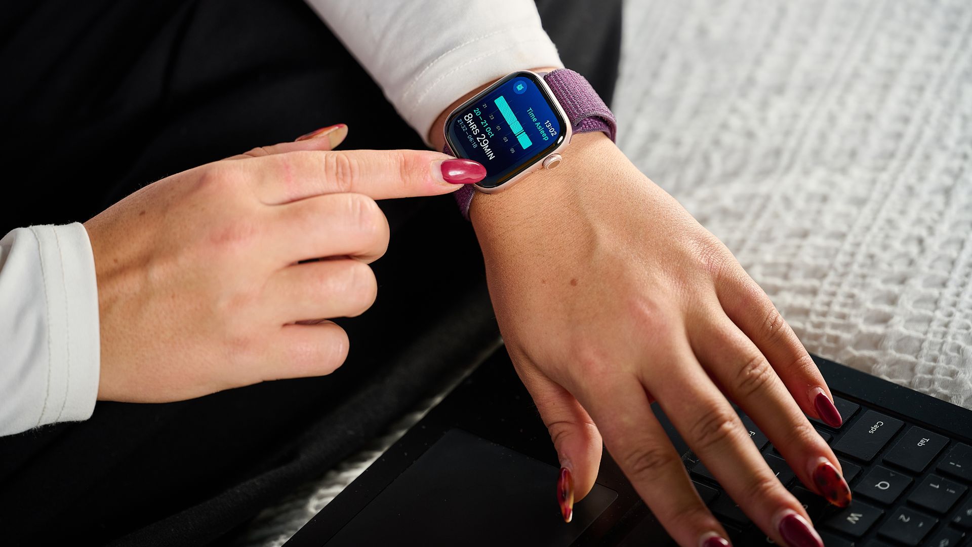 Our sleep tech tester tapping through sleep metrics on the Apple Watch 10 with purple strap 