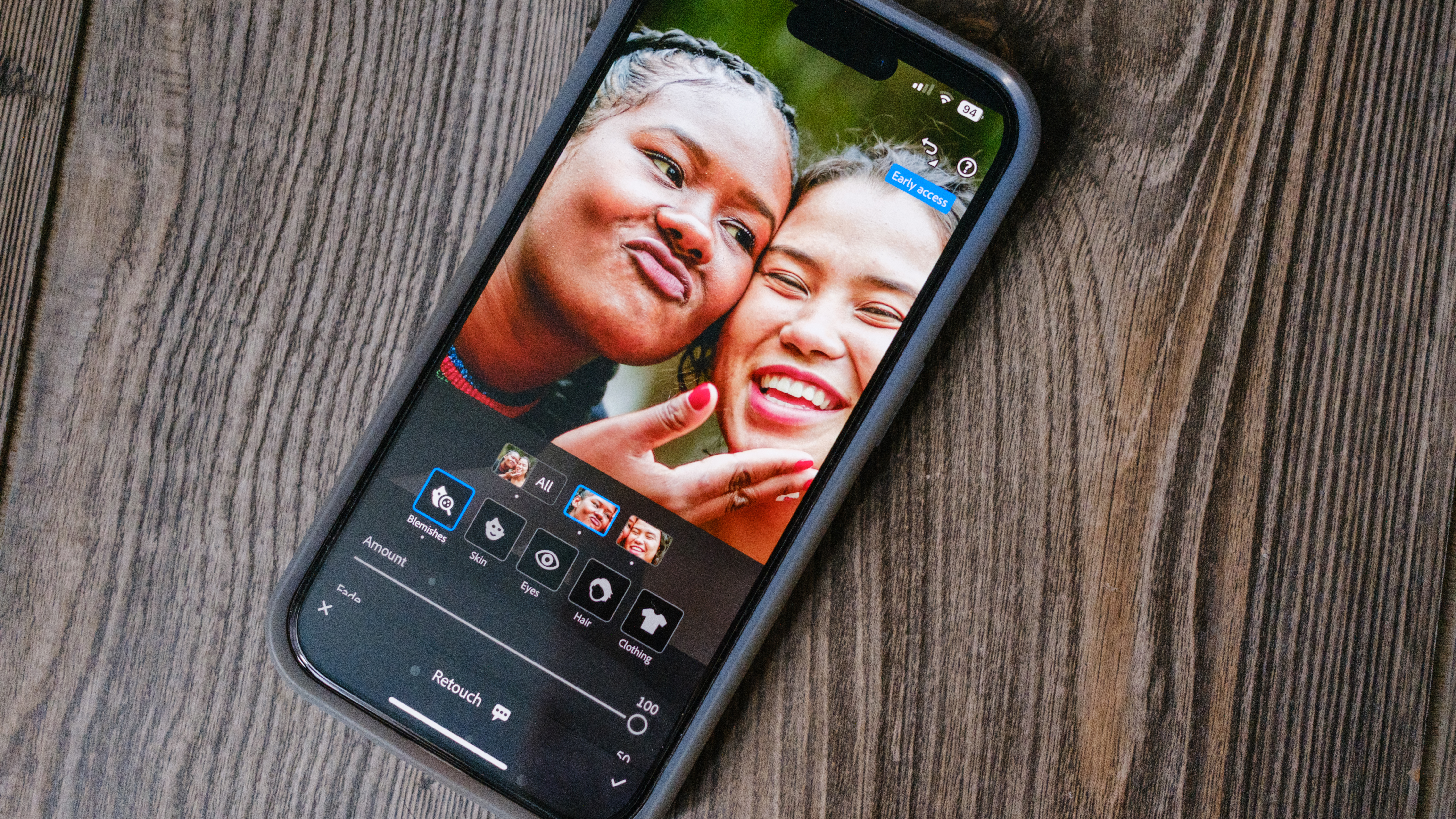 A photo of an iPhone with the Lightroom Mobile blemish slider on the screen