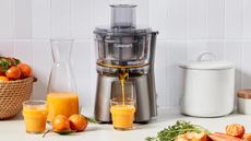 Cuisinart citrus juicer on countertop with glass of juice