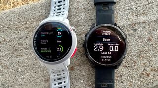 The Garmin Fenix 8 and COROS PACE Pro sitting side by side, showing post-run training load totals.