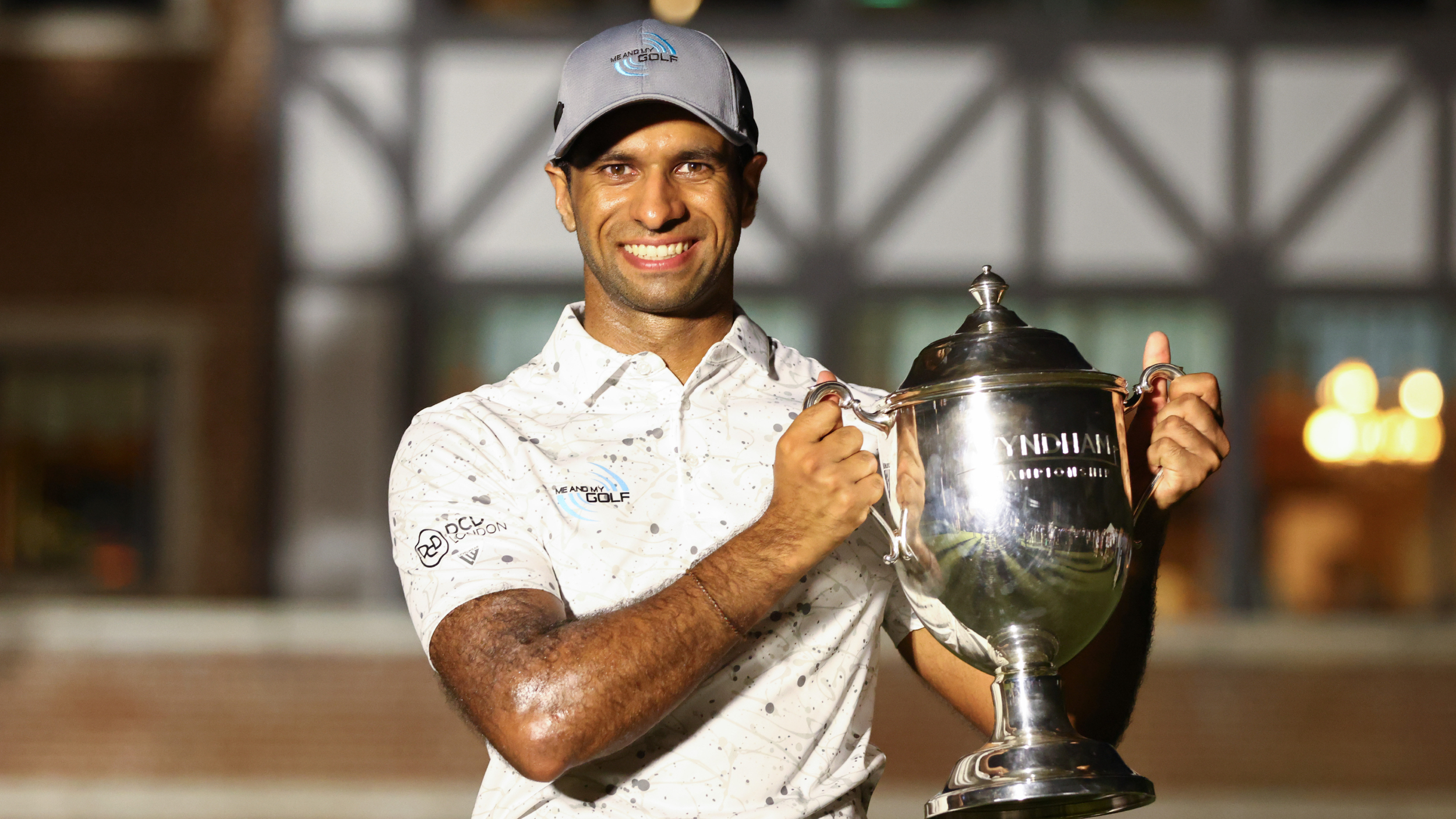 Aaron Rai poses for a photo with the Wyndham Championship trophy