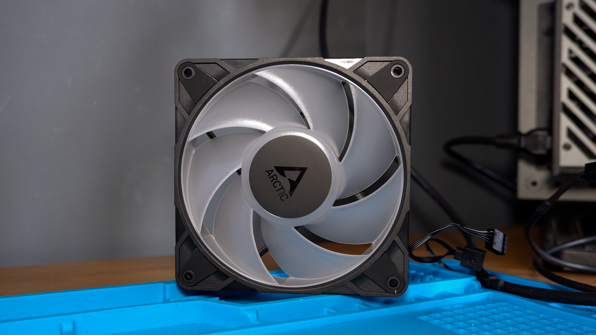 An Arctic Liquid Freezer III Pro liquid cooler set-up on a test bench with the RGB enabled.