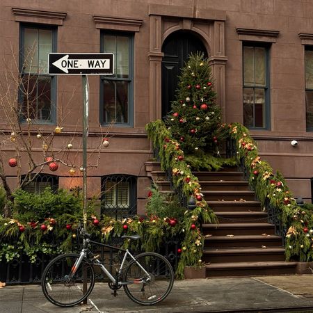 Brownstone with Christmas tree and holiday decorations.